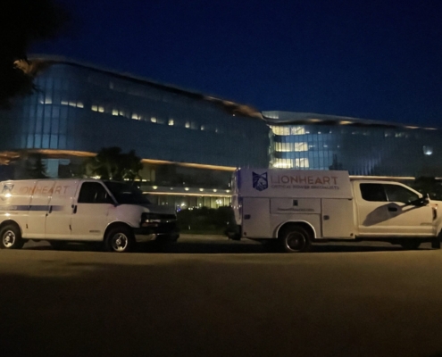 Two LionHeart service trucks parked in the night time