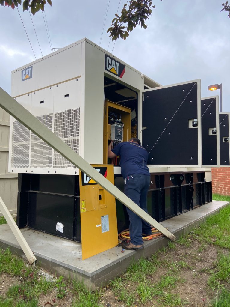 man working on open cat panel