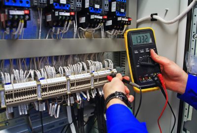 man holding a voltage meter