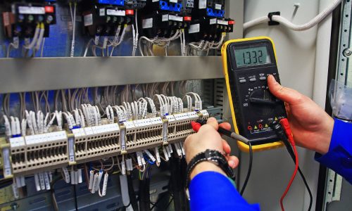 man holding a voltage meter