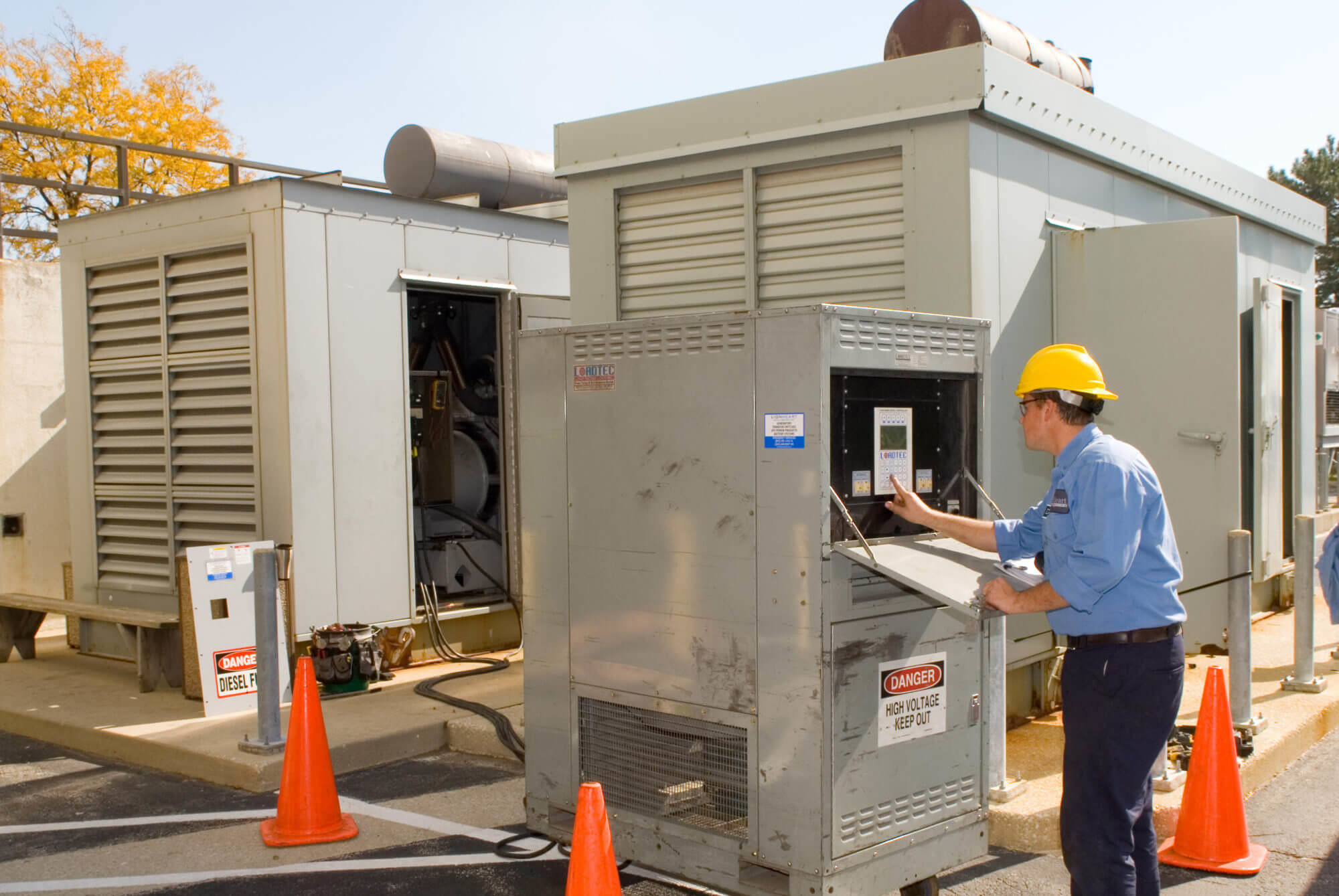 tech in yellow hard hat working with a lordtec load bank