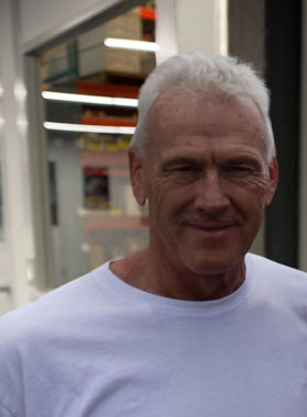 man in white shirt smiling at the camera