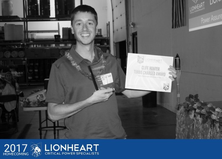 employee cliff hunter holding his turbo charged award